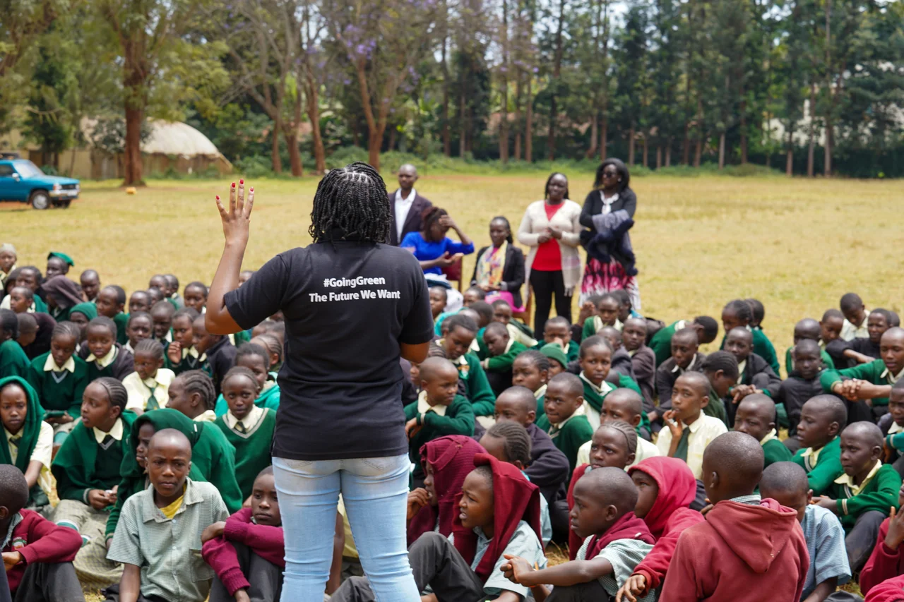 A GGI facilitator speaking to a crowd of students